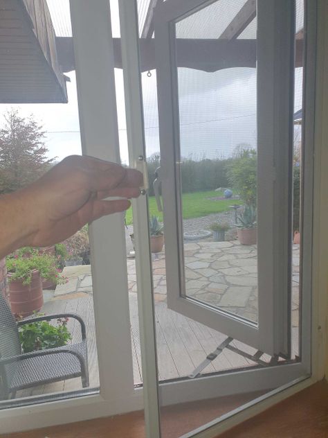 Sliding fly screen installed in a window frame