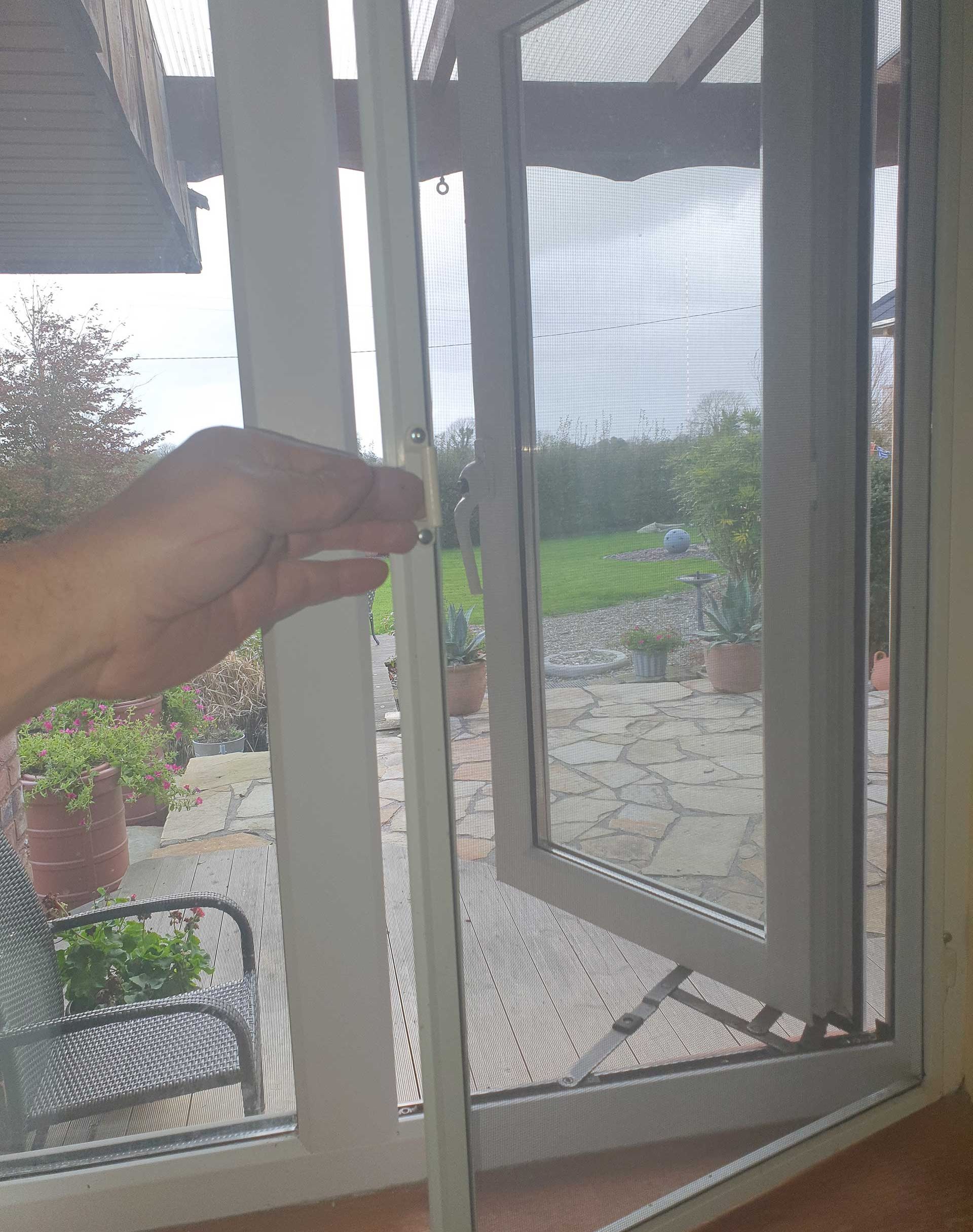 Sliding fly screen installed in a window frame