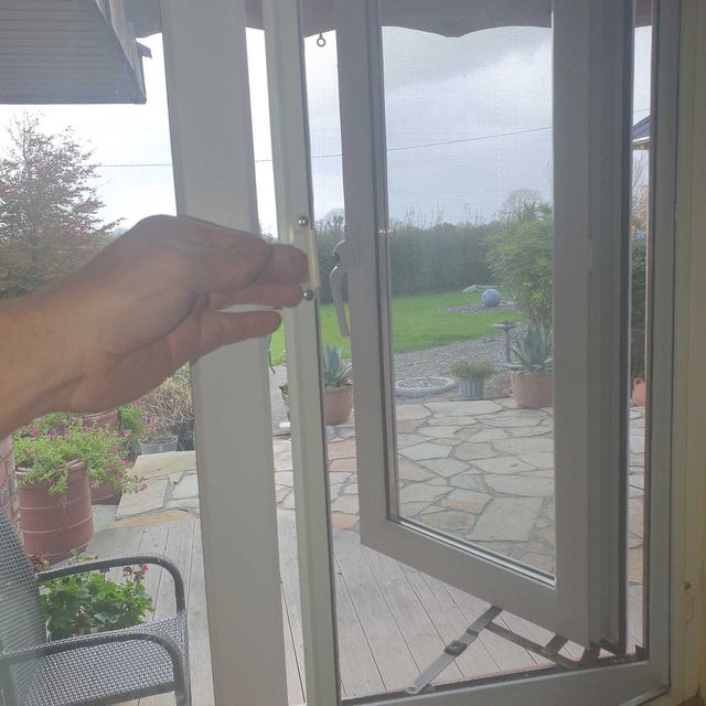 Sliding fly screen installed in a window frame