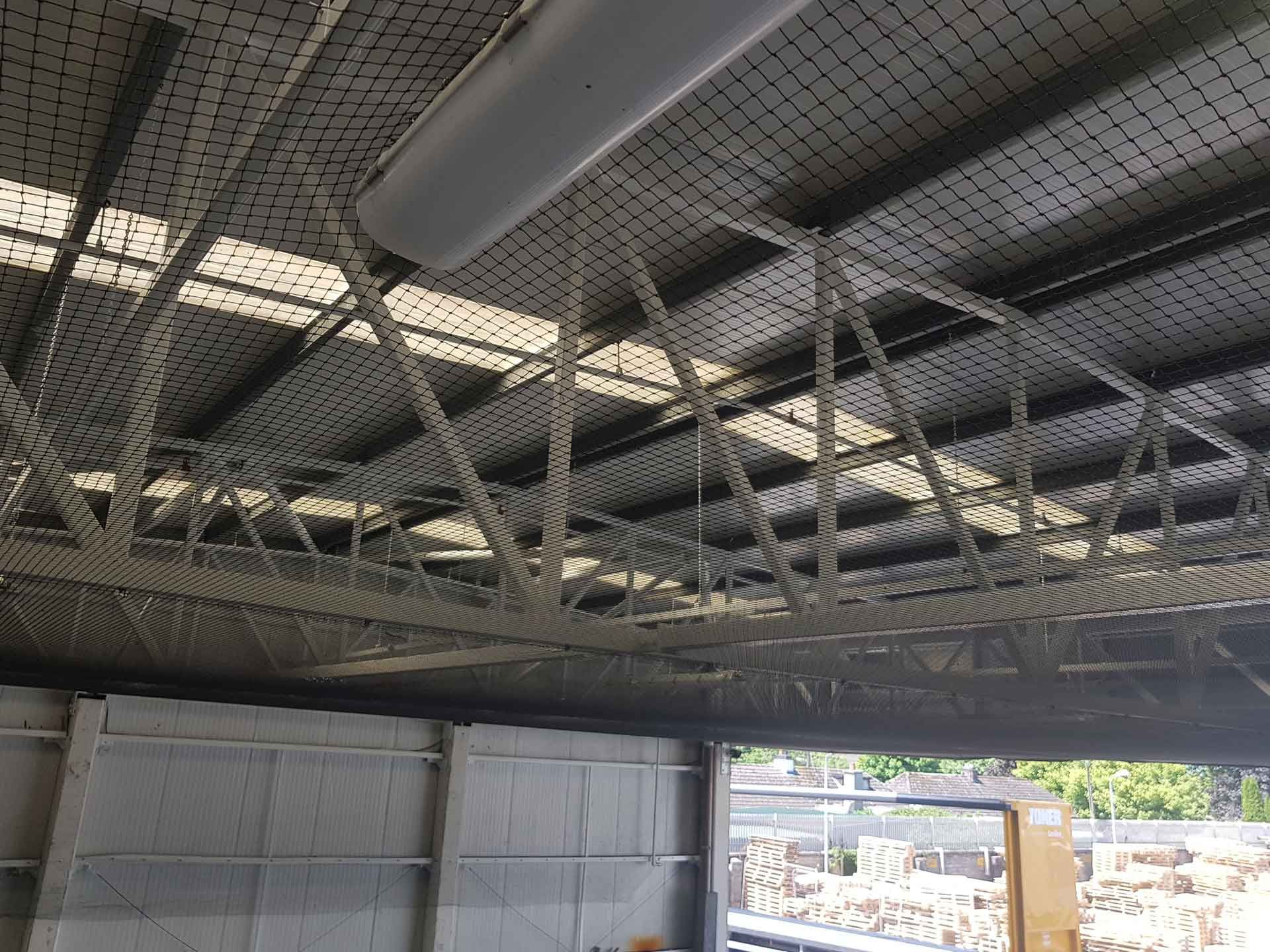 Close up of bird netting installed in a warehouse