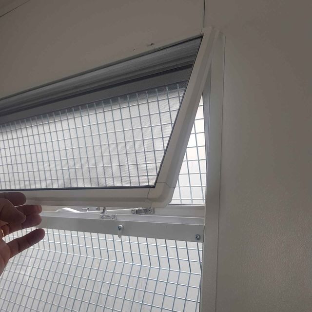 fly screen installed on the inside of a window frame